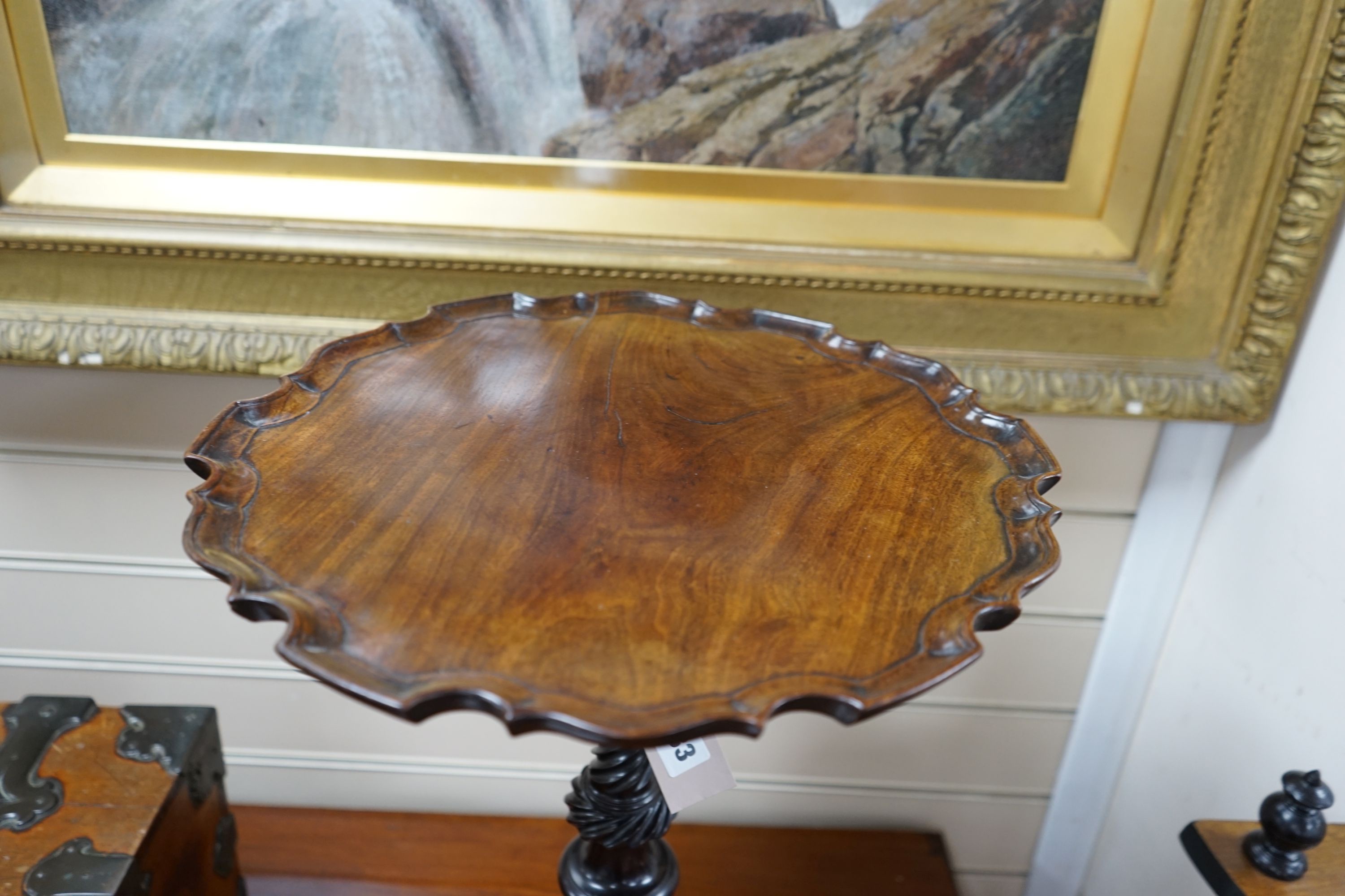 A George III and later mahogany tripod wine table, with circular piecrust top and spiral fluted stem on cabriole tripod base with pointed pad feet, diameter 38cm height 52cm
